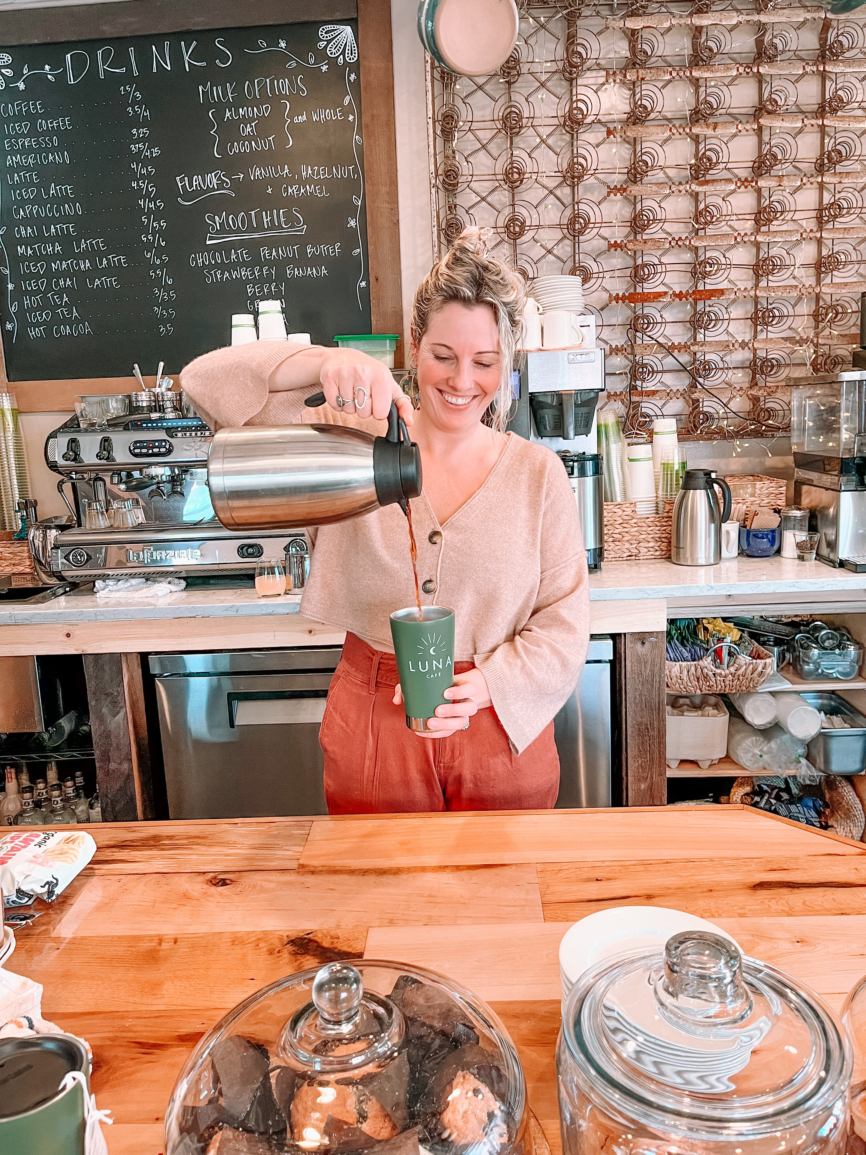 Sarah pouring coffee behind the bar at Luna